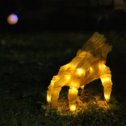 Halloween Electric Luminous Crawling Hand Animated Decoration by Dazzling Dreams Studio, features a glowing zombie hand in a dark outdoor setting, perfect for spooking guests.
