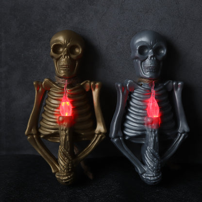 Halloween Decoration Skull Lamp Horror Atmosphere Arrange Hangings featuring a striking gold skeleton holding a red-lit candle.