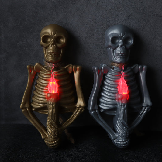 Halloween Decoration Skull Lamp Horror Atmosphere Arrange Hangings featuring a striking gold skeleton holding a red-lit candle.