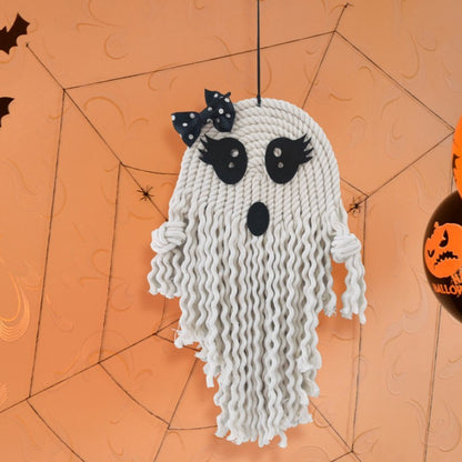 Charming Halloween Ghost Hanging Decoration showcasing a ghost with a polka dot bow, embodying whimsical elegance against an orange backdrop filled with spider decorations, perfect for festive settings.