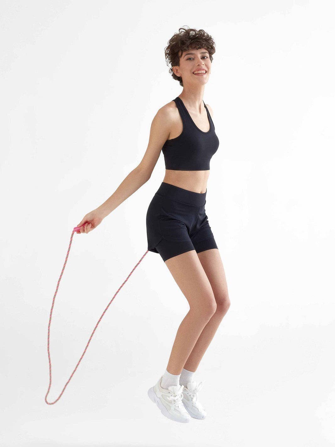 Luxurious Sustainable Women's Recycled Double Layer Cycling Shorts in a stylish setting, crafted from 100% recycled polyester for eco-friendly fashion.