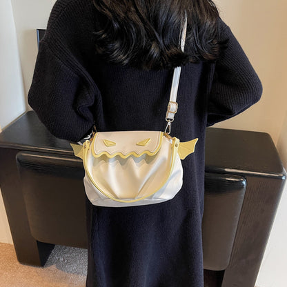 Funny Crossbody Bag - Halloween Pumpkin Cartoon Design in luxurious white, showcasing its charming wings and exquisite details against a fashionable attire.