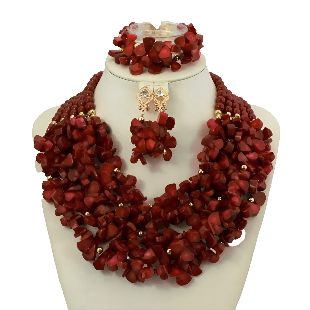 Complete African coral beads jewelry set displayed elegantly, including necklace, earrings, and bracelet, perfect for brides and anniversaries.