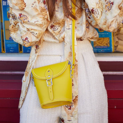 Interior view of the handmade green leather barrel bag, featuring a spacious compartment ideal for everyday essentials, perfect for luxurious styling.