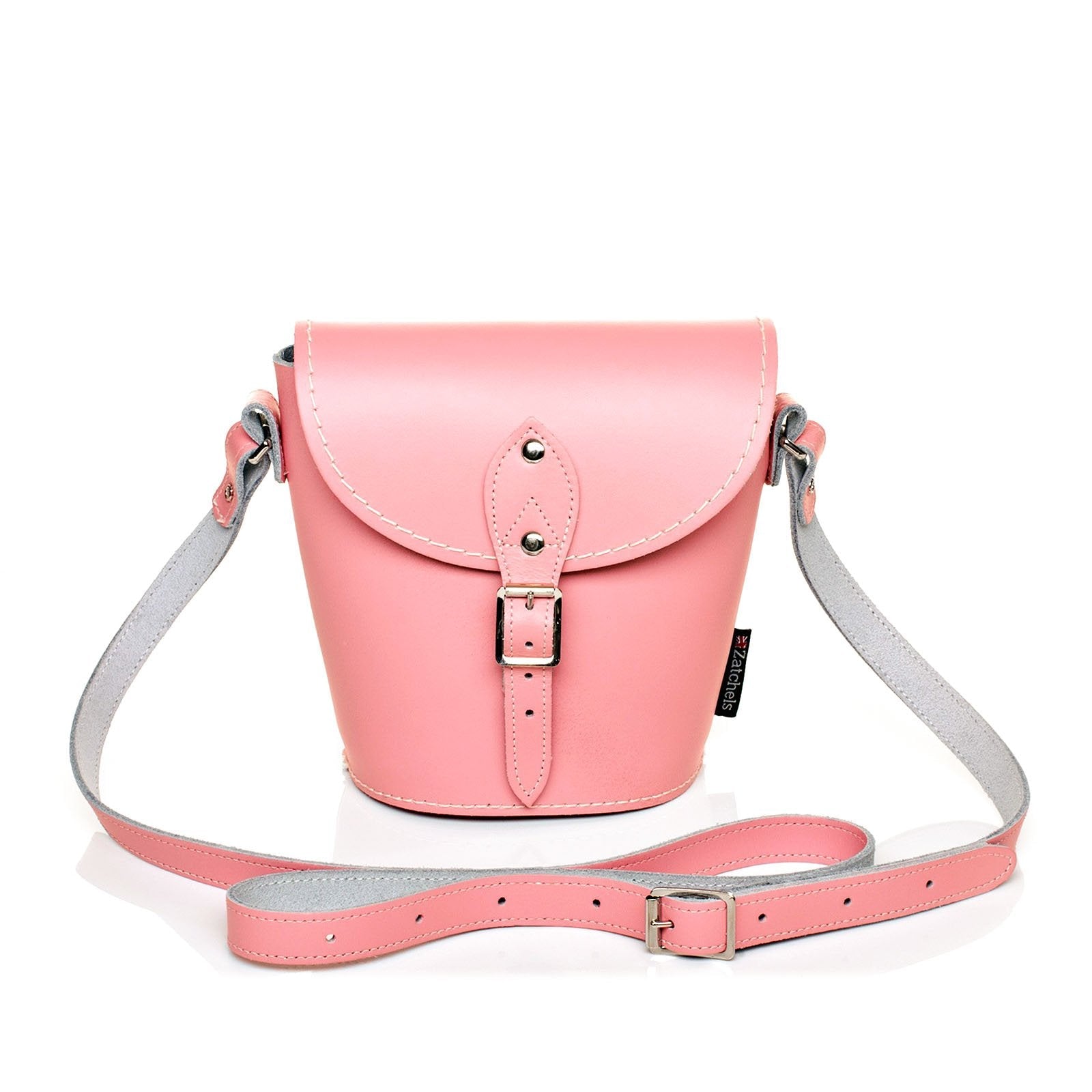 Handcrafted pastel pink leather barrel bag with adjustable strap, showcasing stylish design and elegant polished silver nickel buckle, ideal for accessorising any outfit.