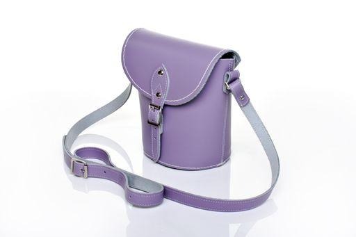 Elegant handmade pastel violet leather barrel bag featuring an adjustable strap, showcasing exquisite craftsmanship and luxurious design, perfect for enhancing any outfit.
