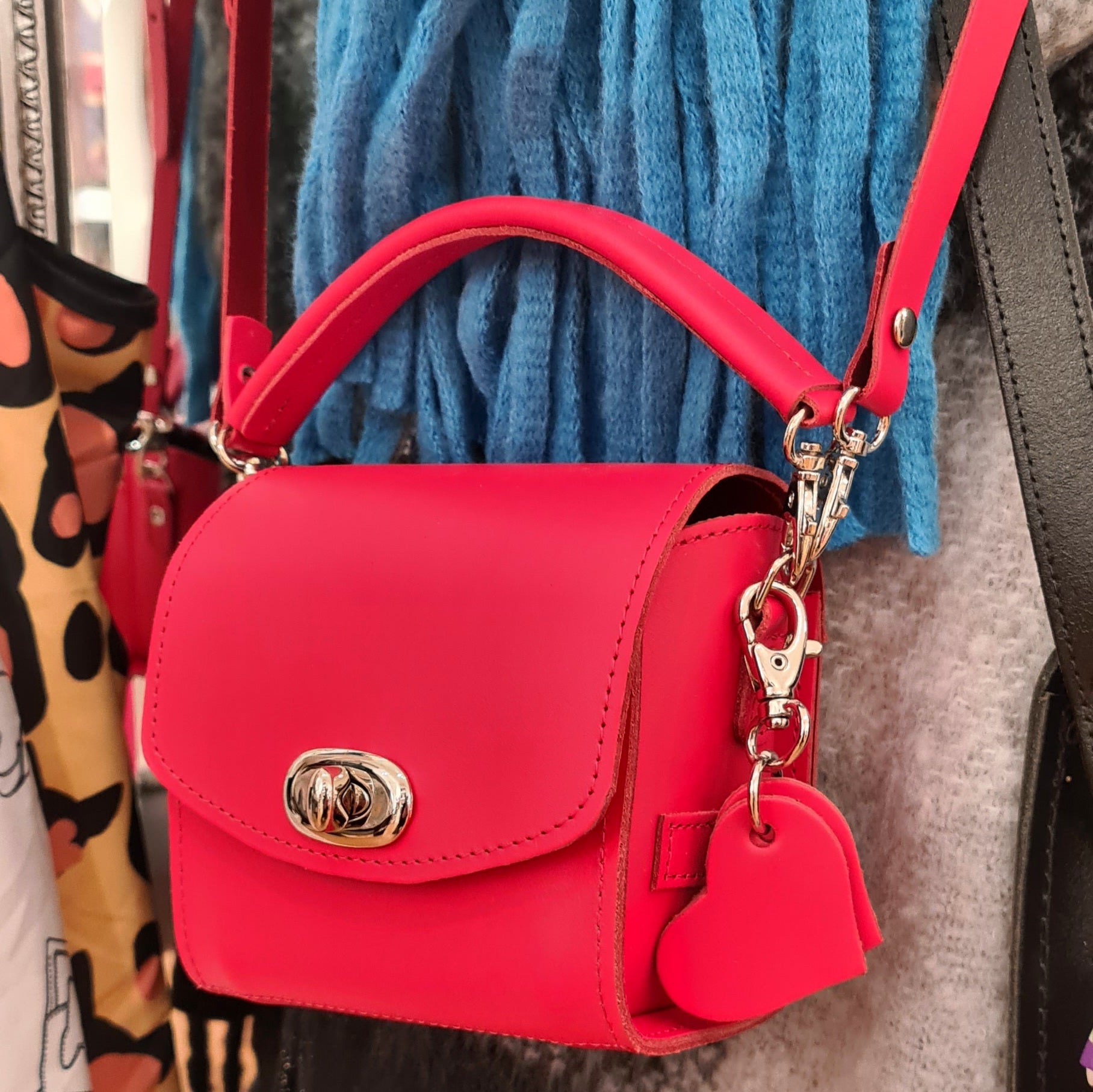 The charming interior of the Handmade Bauble Leather Handbag in Pillar Box Red, demonstrating ample space for essentials like a purse, keys, and lipstick in a luxurious design.