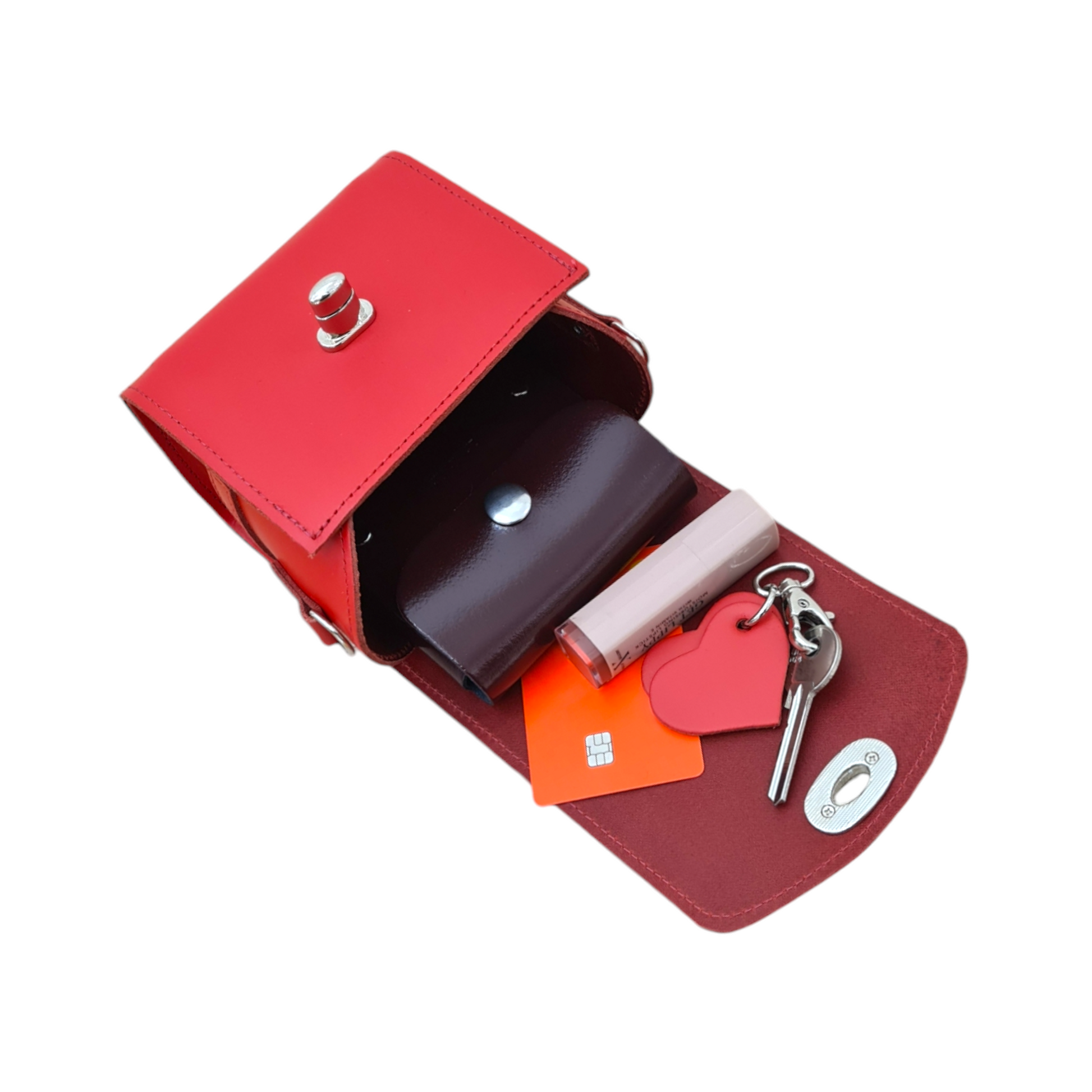 Stylish display of the Handmade Bauble Leather Handbag, elegantly showcased against a contrasting background, highlighting its vibrant Pillar Box Red finish and luxurious design.