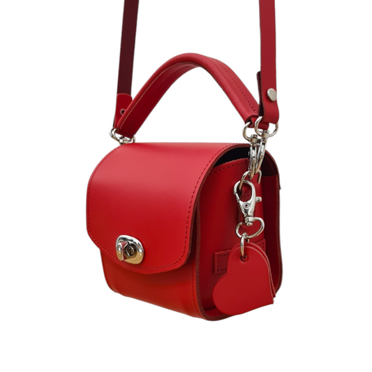 Luxurious Handmade Bauble Leather Handbag in Pillar Box Red with elegant heart charm, showcasing exquisite craftsmanship and impeccable style.
