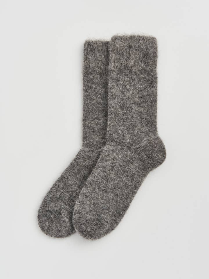 Close-up of premium alpaca bed socks, highlighting their exquisite craftsmanship and fine materials, perfect for indulgent relaxation.