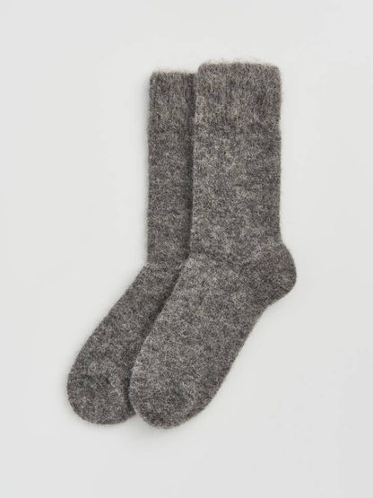 Close-up of premium alpaca bed socks, highlighting their exquisite craftsmanship and fine materials, perfect for indulgent relaxation.
