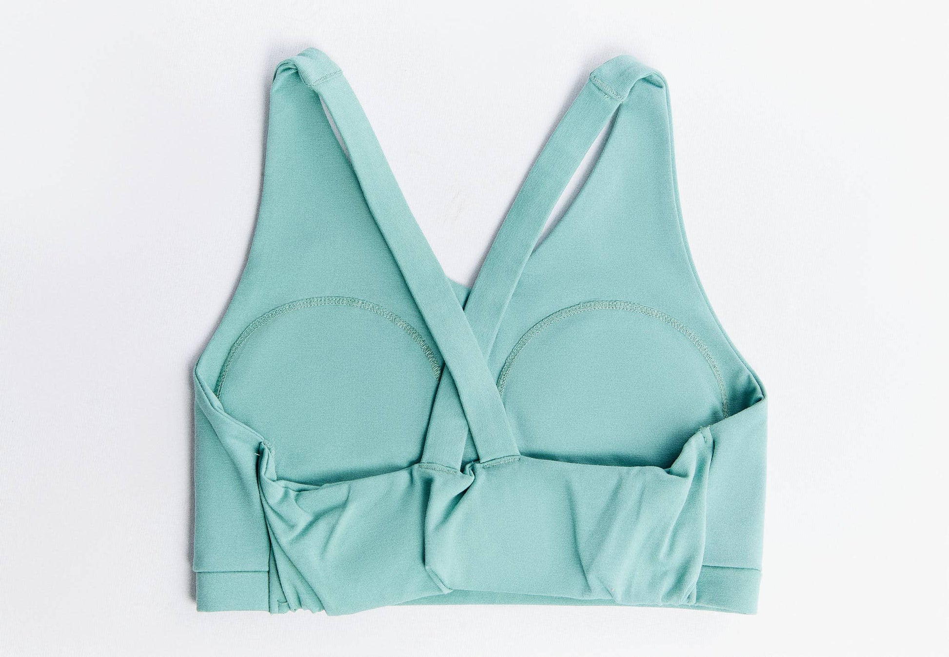 Lifestyle image of a chic V-neck padded sports bra designed for everyday comfort and athletic performance, featuring a sustainable luxury design by Earth Wardrobe.