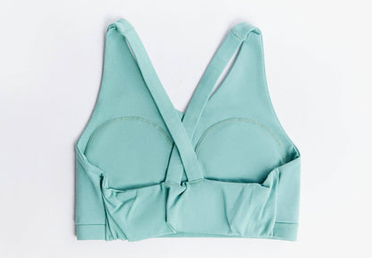 Lifestyle image of a chic V-neck padded sports bra designed for everyday comfort and athletic performance, featuring a sustainable luxury design by Earth Wardrobe.