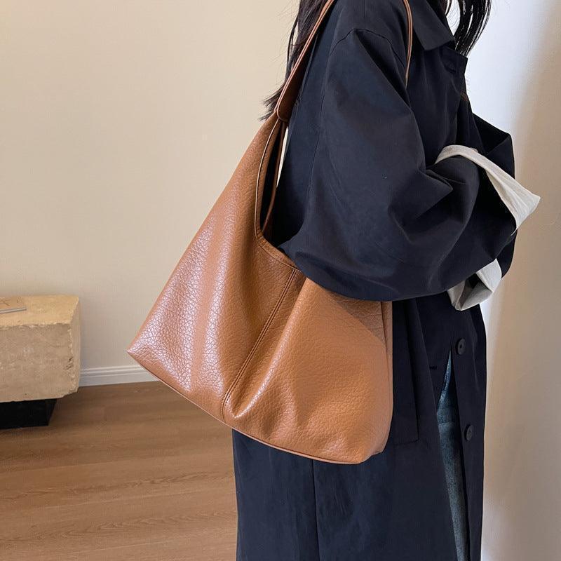 Scene featuring luxury faux leather shoulder bag and wallet on a stylish backdrop, ideal for modern fashionistas.