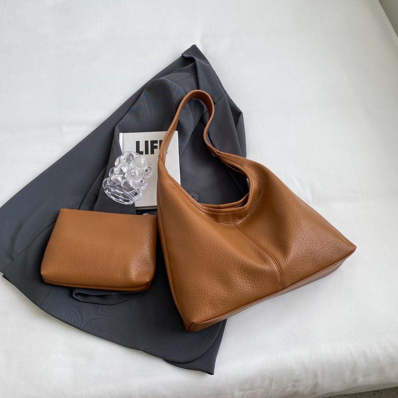 Exquisite faux leather shoulder bag and wallet set designed for modern women, embodying luxury and practicality.