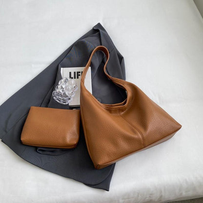 Exquisite faux leather shoulder bag and wallet set designed for modern women, embodying luxury and practicality.