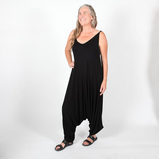 Elegant black harem jumpsuit showcasing adjustable shoulder ties, designed for comfort and style, perfect for UK sizes 8-16.
