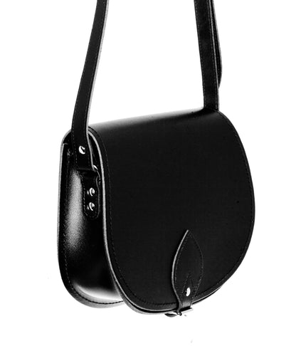 Stylish black leather saddle bag with oversized front flap, featuring exquisite stitching and available in two sizes.
