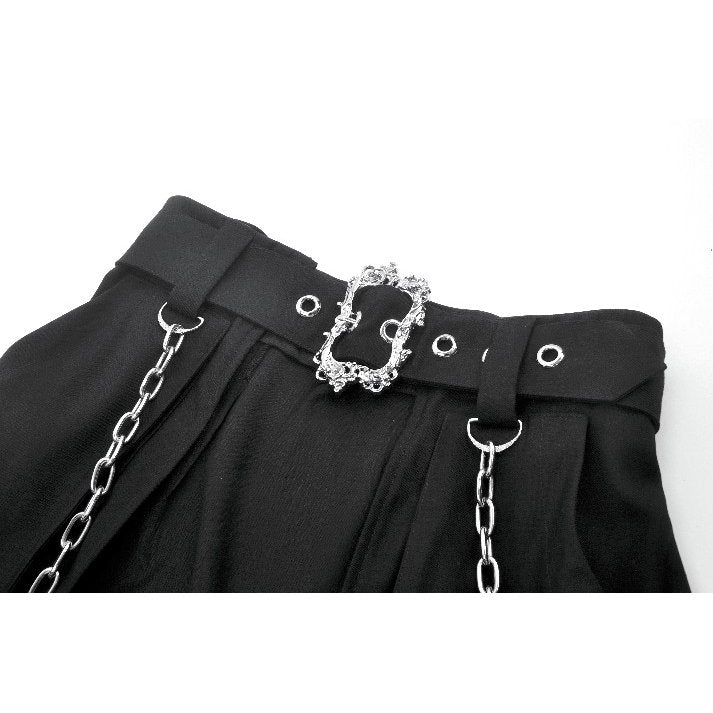 Model showcasing the Dark in Love layered goth skirt in a dynamic pose, embodying gothic rebellion and stylish confidence with split fronts and chain accents.