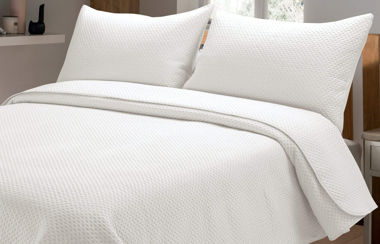 Stylishly arranged Capri Bedspread Set on a bed, blending elegance with functionality, perfect for enhancing modern home interiors.