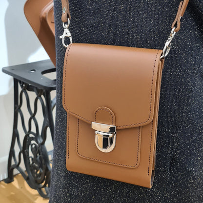 Close-up of Zatchels Luxury Leather Crossbody Phone Case, highlighting the adjustable strap and secure push lock closure.