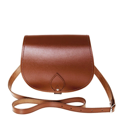 Elegant Handmade Chestnut Leather Saddle Bag showcasing timeless design with contrasting stitching and adjustable strap, perfect for luxury daily wear.