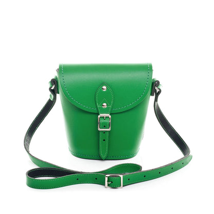 Handmade green leather barrel bag showcasing adjustable strap and elegant silver nickel buckle, perfect for versatile styling and personalised luxury accessories.