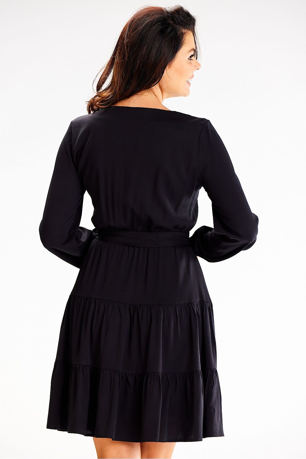 Close-up of Awama’s exquisite long sleeve flared dress, highlighting the delicate ruffles and tailored belt for a chic silhouette.