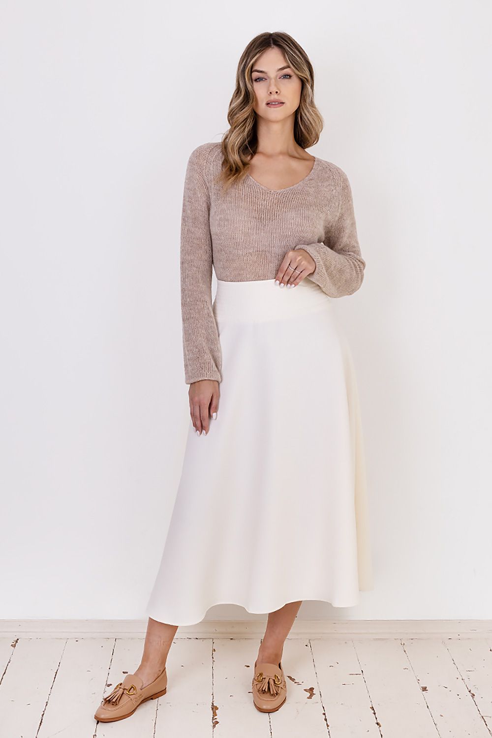 Back view of MKM Transparent Sweater highlighting the loose form and understated elegance, suitable for the colder season.