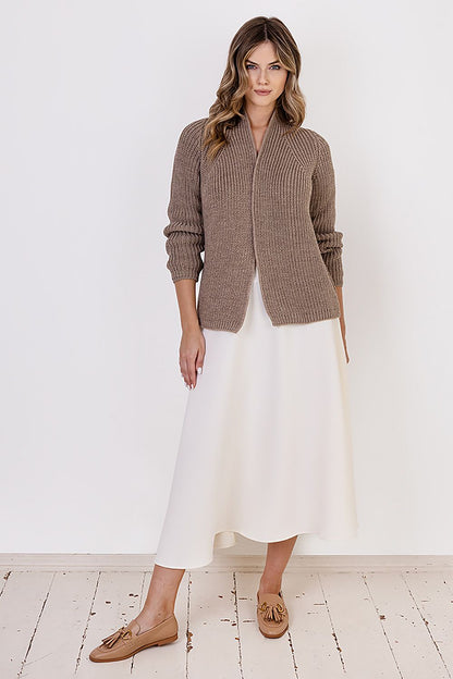 MKM ribbed cardigan worn with elegant attire, exemplifying versatility and luxury for cold weather fashion.