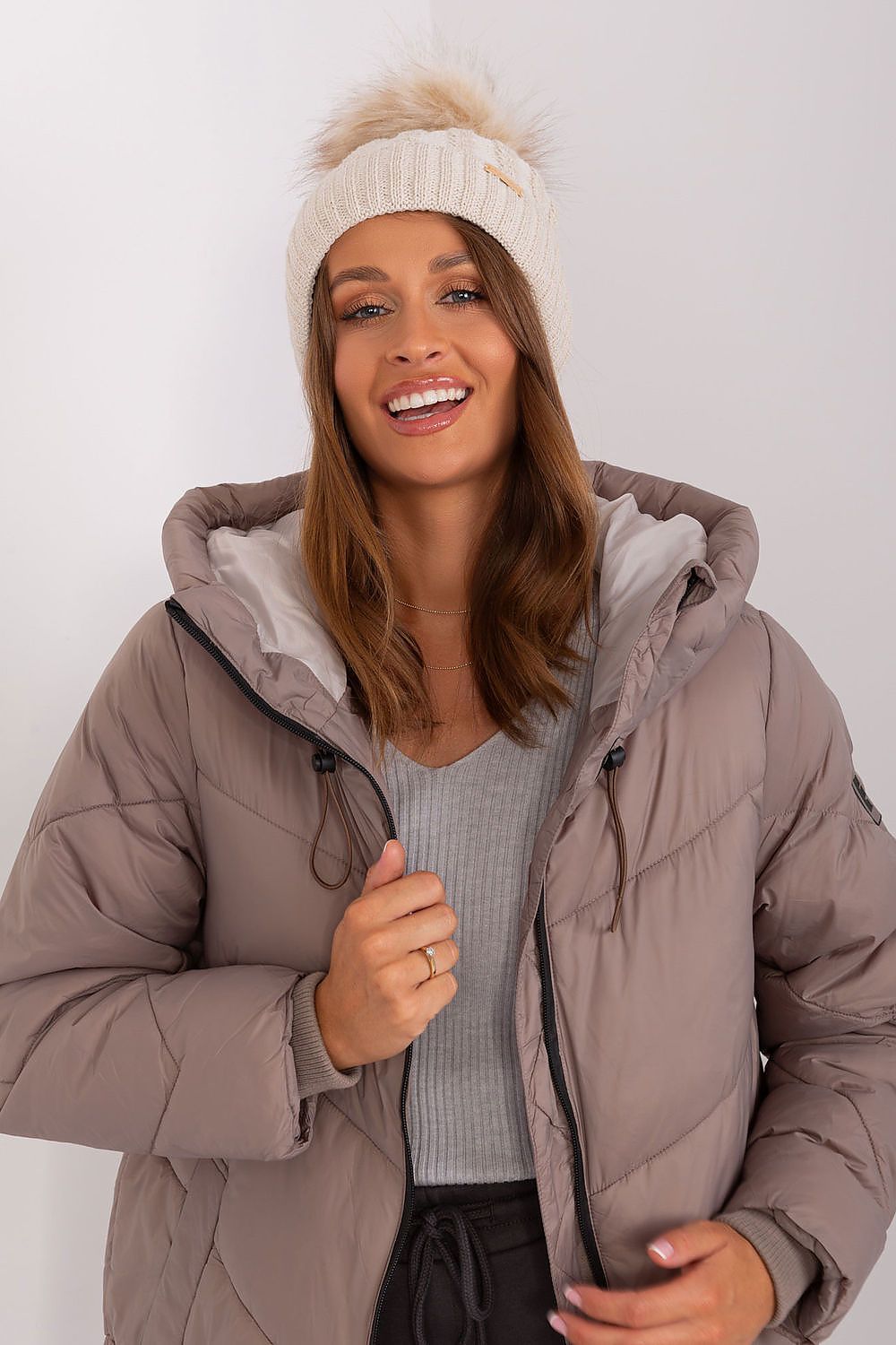 Luxury women's winter beanie by Rue Paris, featuring a stylish turn-up design, sophisticated plaid weave, and playful pom-pom, crafted from 70% acrylic and 30% wool.