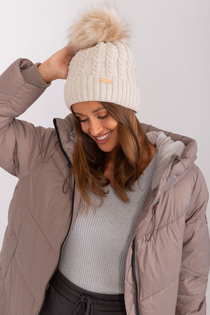 Luxury women's winter beanie by Rue Paris, featuring a stylish turn-up design, plaid weave, and elegant pom-pom detail, made from 70% acrylic and 30% wool.