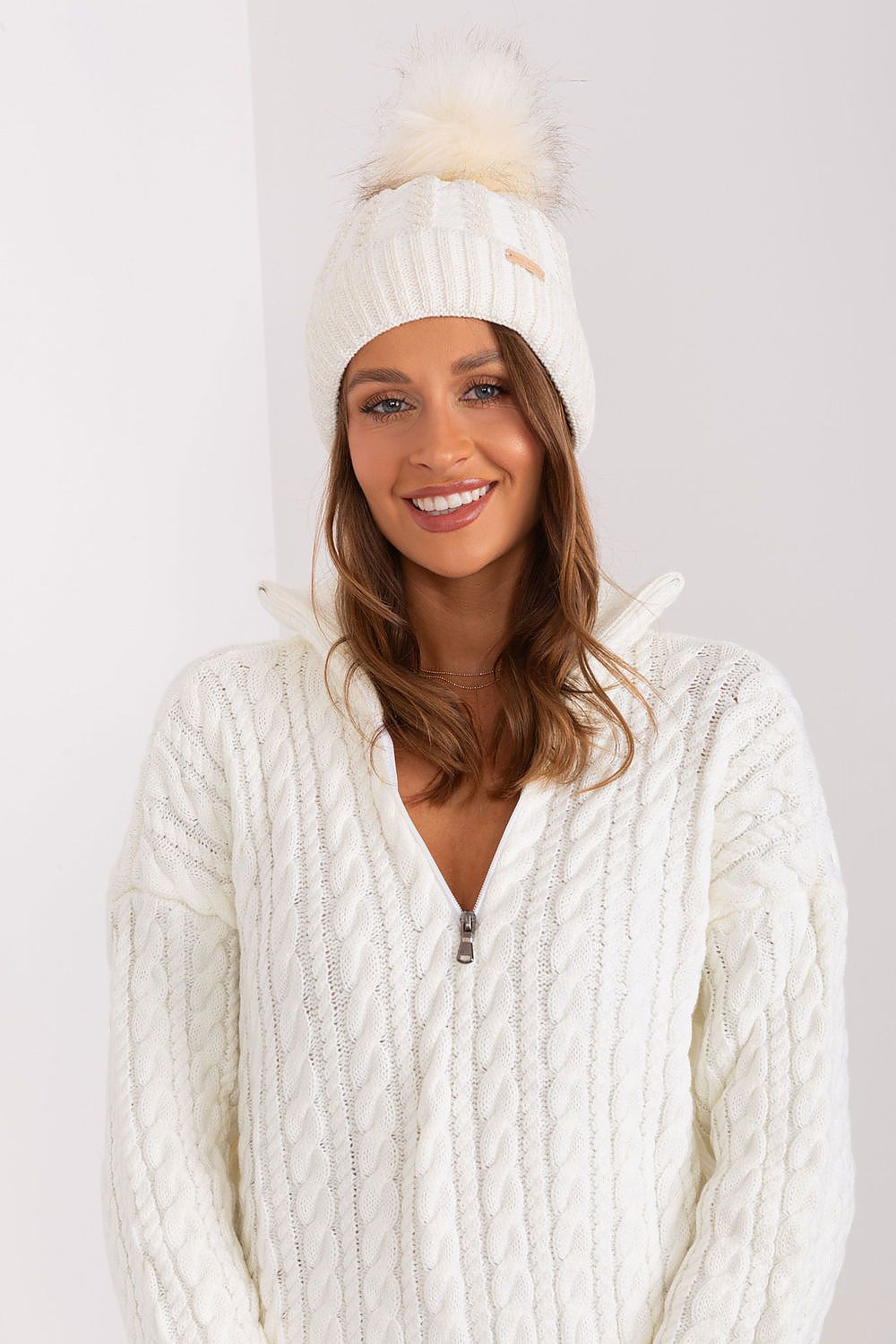 Close-up view of Rue Paris luxury winter beanie with turn-up, showcasing the intricate plaid weave pattern and plush pom-pom, crafted from premium acrylic and wool.