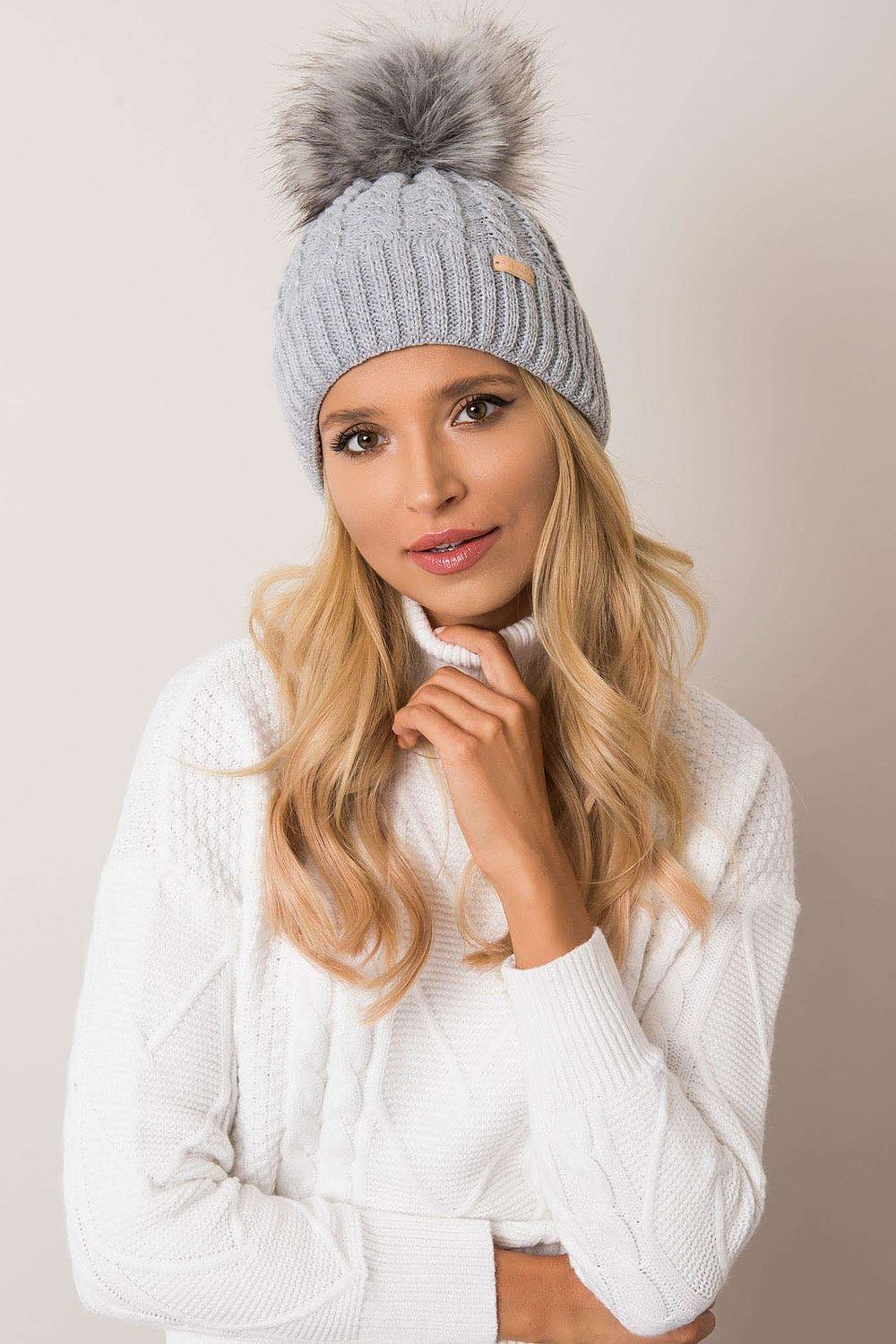 Stylish and warm luxury winter beanie for women by Rue Paris, featuring a fashionable turn-up brim, unique plaid pattern, and playful pom-pom, made from an acrylic-wool blend.