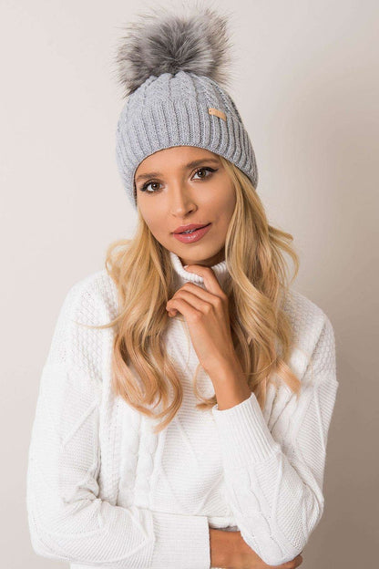 Stylish and warm luxury winter beanie for women by Rue Paris, featuring a fashionable turn-up brim, unique plaid pattern, and playful pom-pom, made from an acrylic-wool blend.