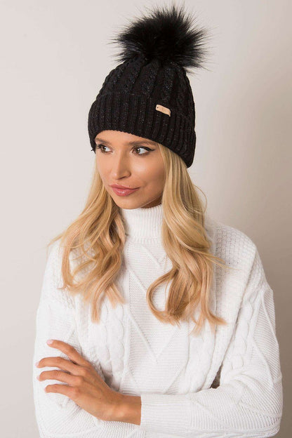 Model wearing Rue Paris luxury plaid winter beanie with turn-up and pom-pom, exuding sophistication and warmth during winter.