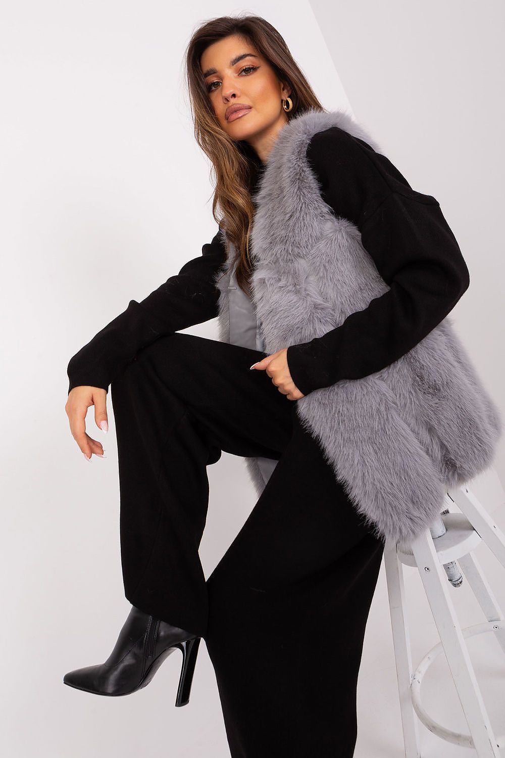 Elegant polyester fur vest by AT showcased with a chic design, featuring convenient slip pockets for practicality and comfort during fall and winter.