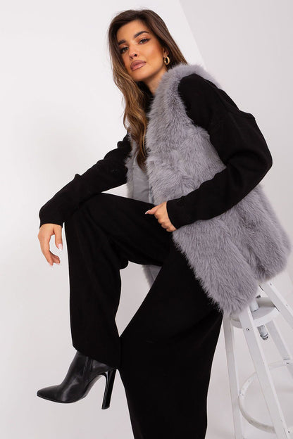 Elegant polyester fur vest by AT showcased with a chic design, featuring convenient slip pockets for practicality and comfort during fall and winter.