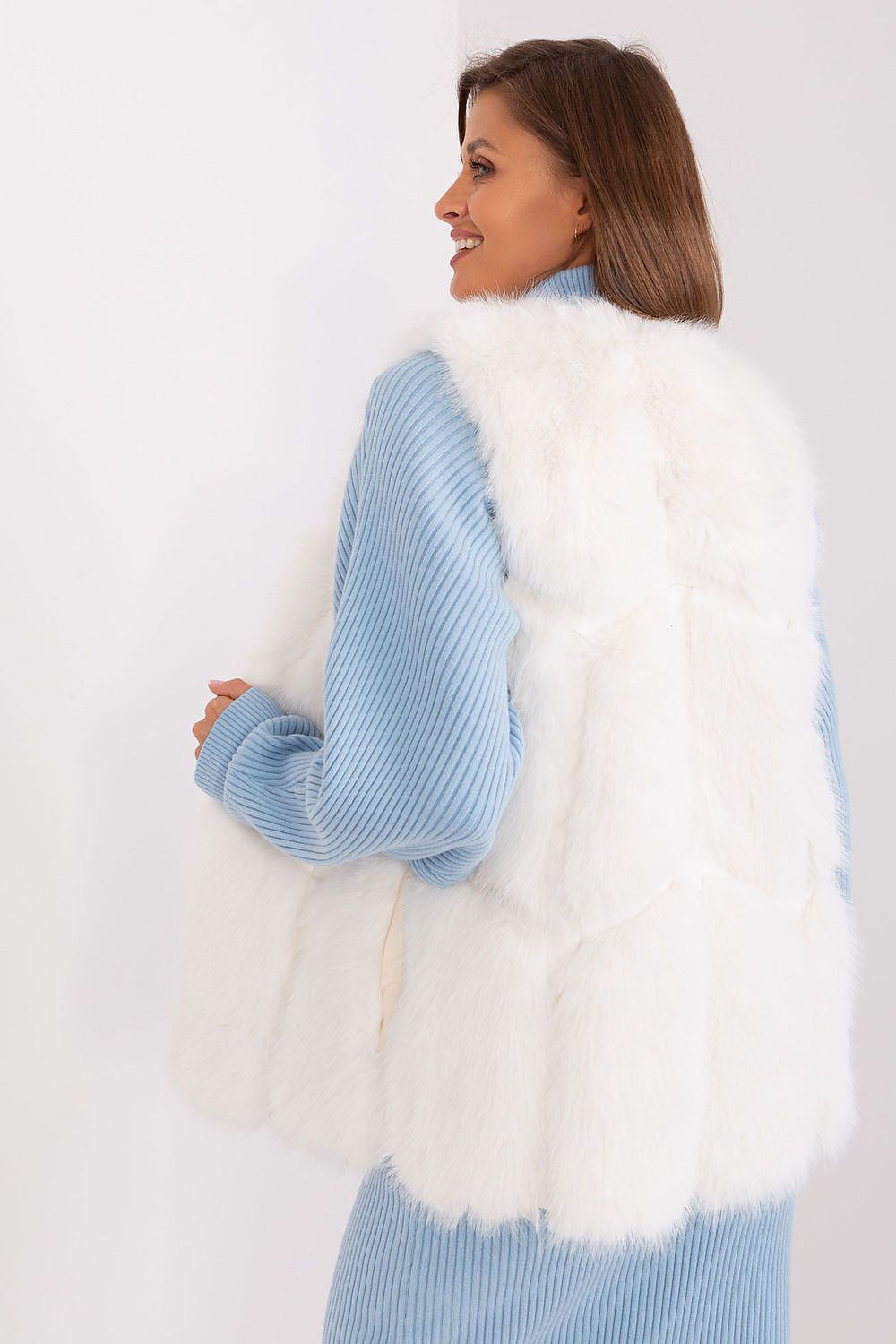Sophisticated and comfortable polyester fur vest by AT, featuring convenient slip pockets for practicality and style.