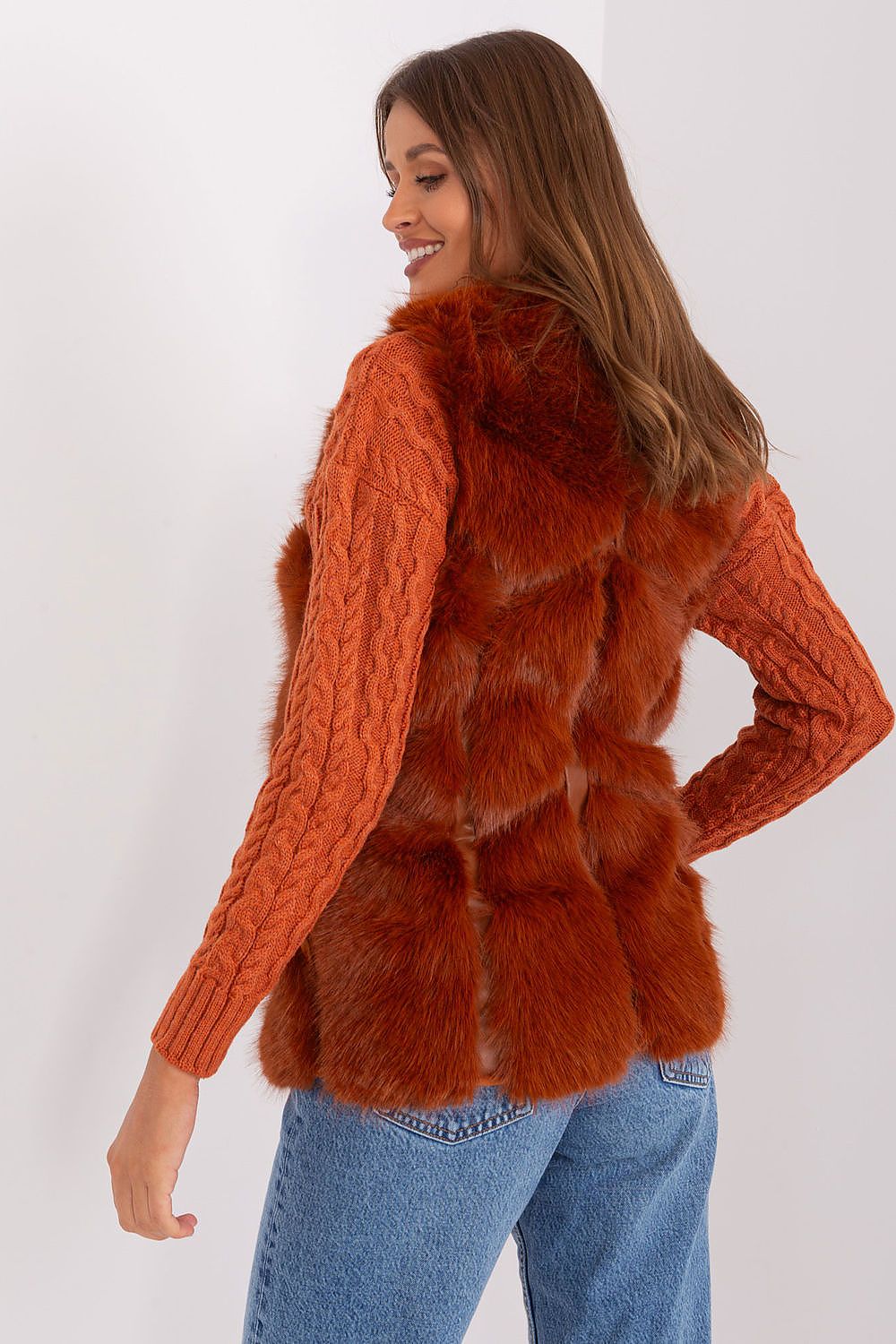 Sophisticated fur vest made from soft polyester by AT, featuring a versatile design with slip pockets, ideal for elevating daily attire in colder weather.