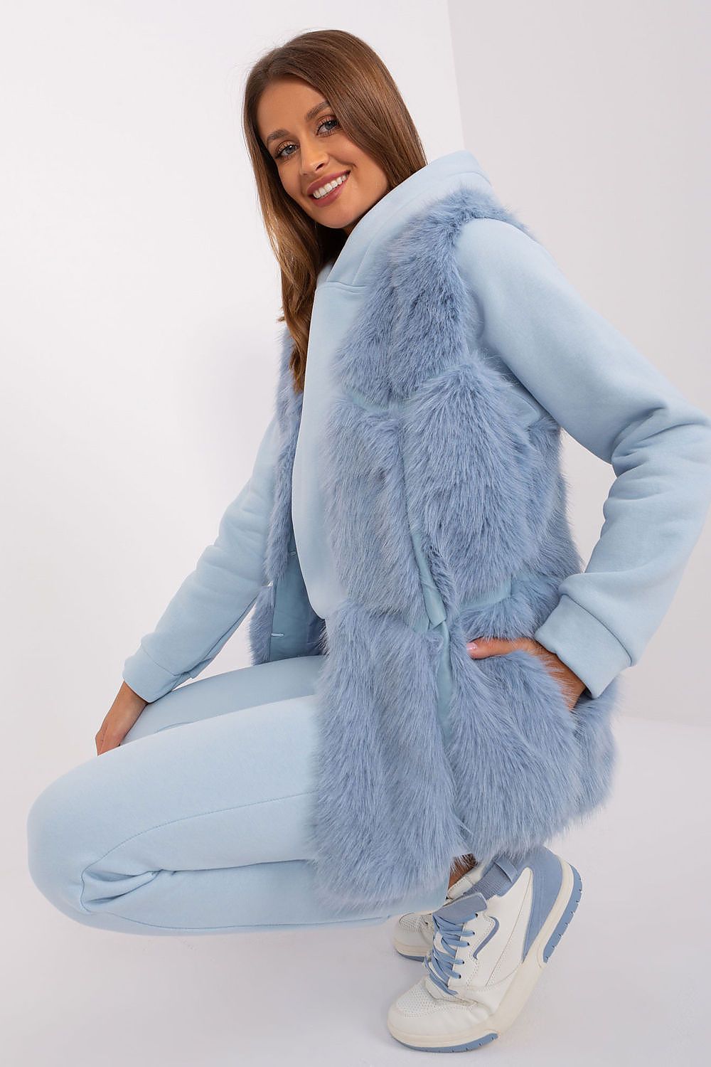 AT's stylish polyester fur vest, complete with practical slip pockets and hook-and-loop closure, embodying luxury and practicality.