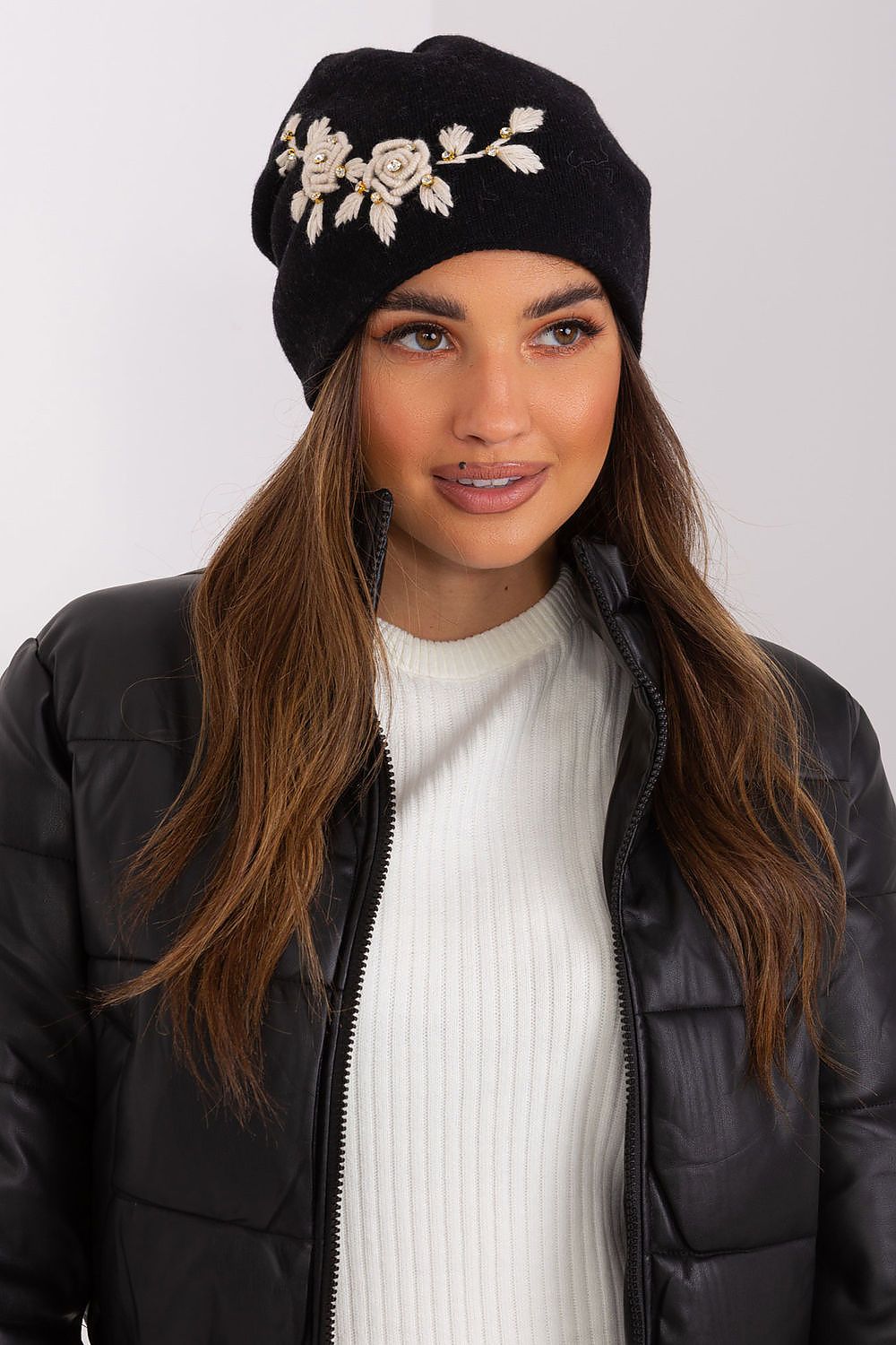 Luxury women's winter hat by AT, crafted from smooth knit fabric, featuring decorative applique and a blend of acrylic, cotton, and cashmere for ultimate warmth and style during cold weather.