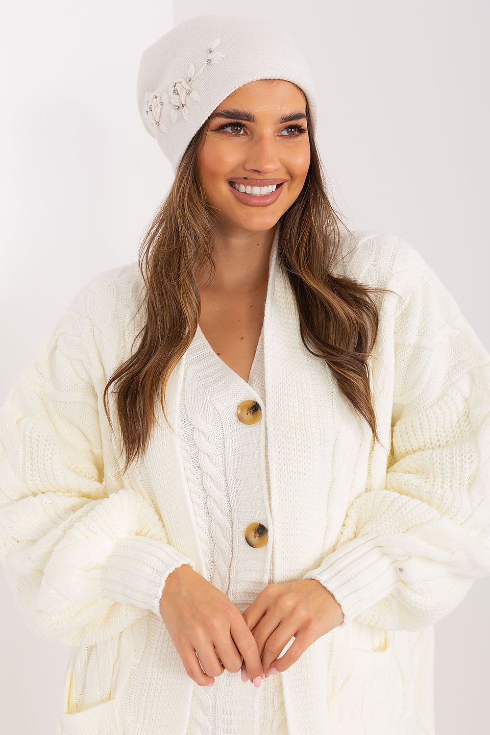 Chic winter hat in luxurious materials by AT, combining 50% acrylic, 30% cotton, and 20% cashmere with a unique decorative applique.