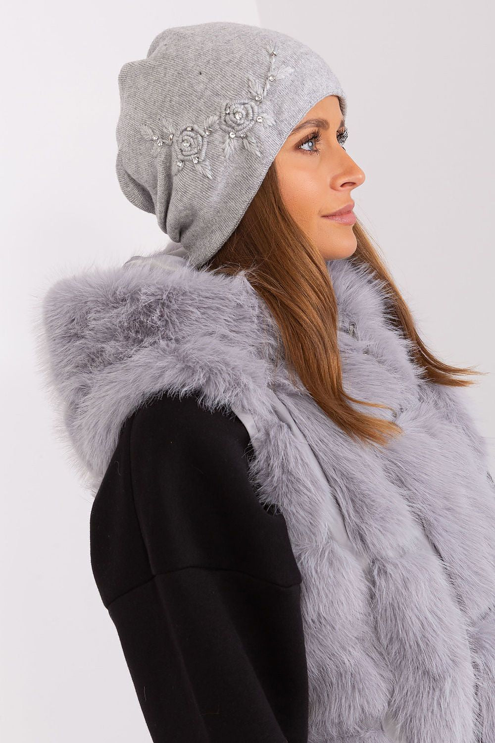Elegant women's winter hat by AT, made from premium smooth knit with decorative elements, perfect for chilly weather.