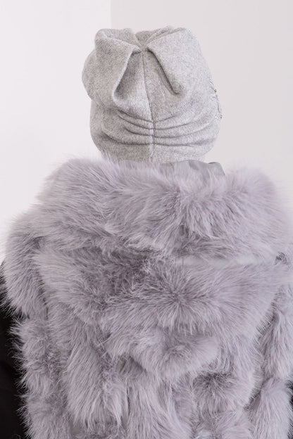 Luxurious smooth knit winter hat for women by AT, showcasing decorative applique for a refined and chic look.