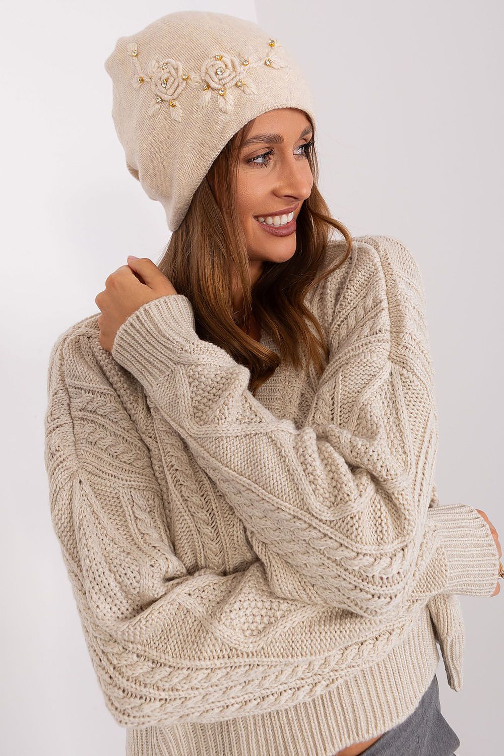 Luxury women's winter hat by AT in smooth knit with decorative applique, crafted from 50% acrylic, 30% cotton, and 20% cashmere for ultimate warmth and style.