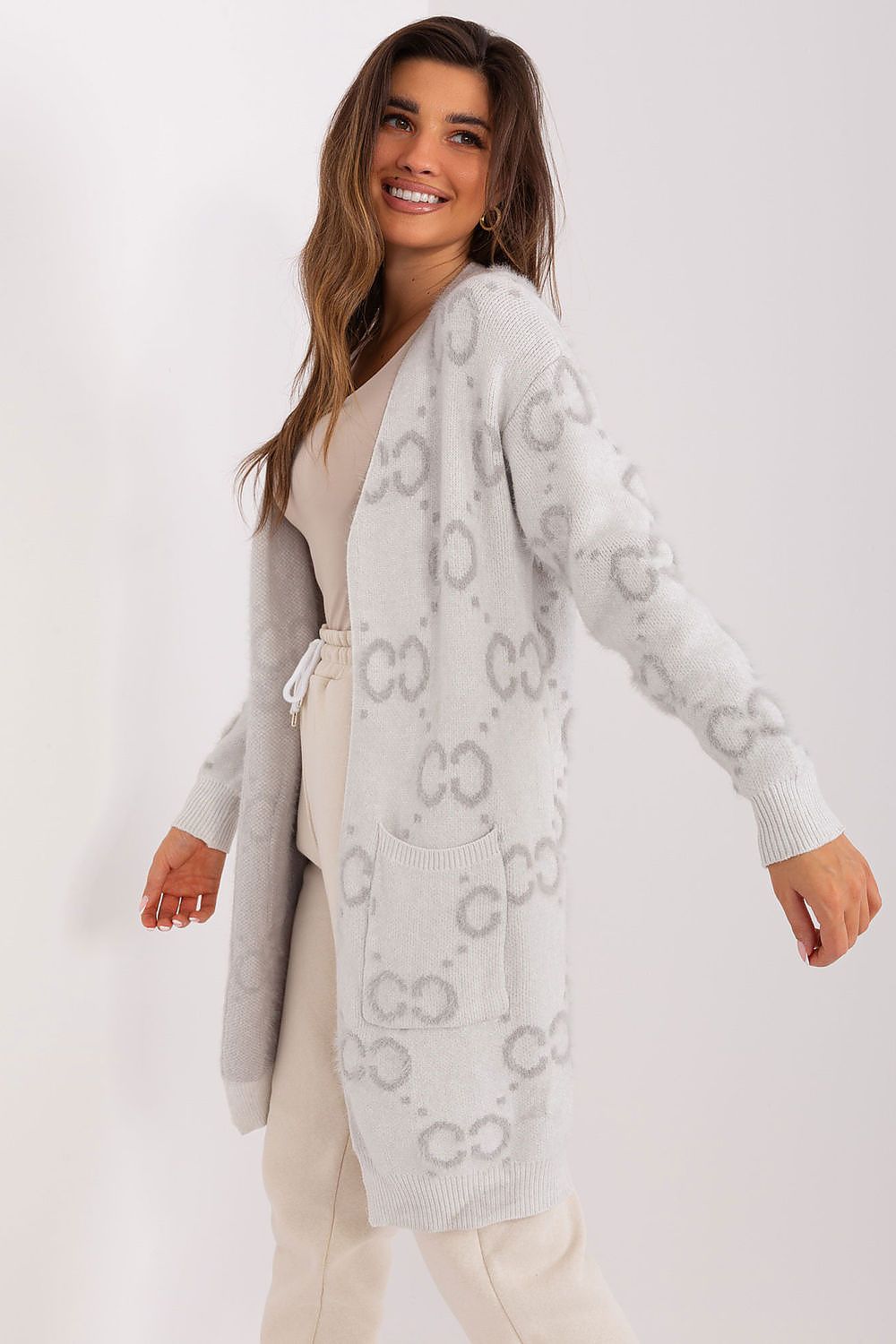 Versatile knee-length cardigan designed by AT, featuring practical pockets and an intricate print for a sophisticated look.