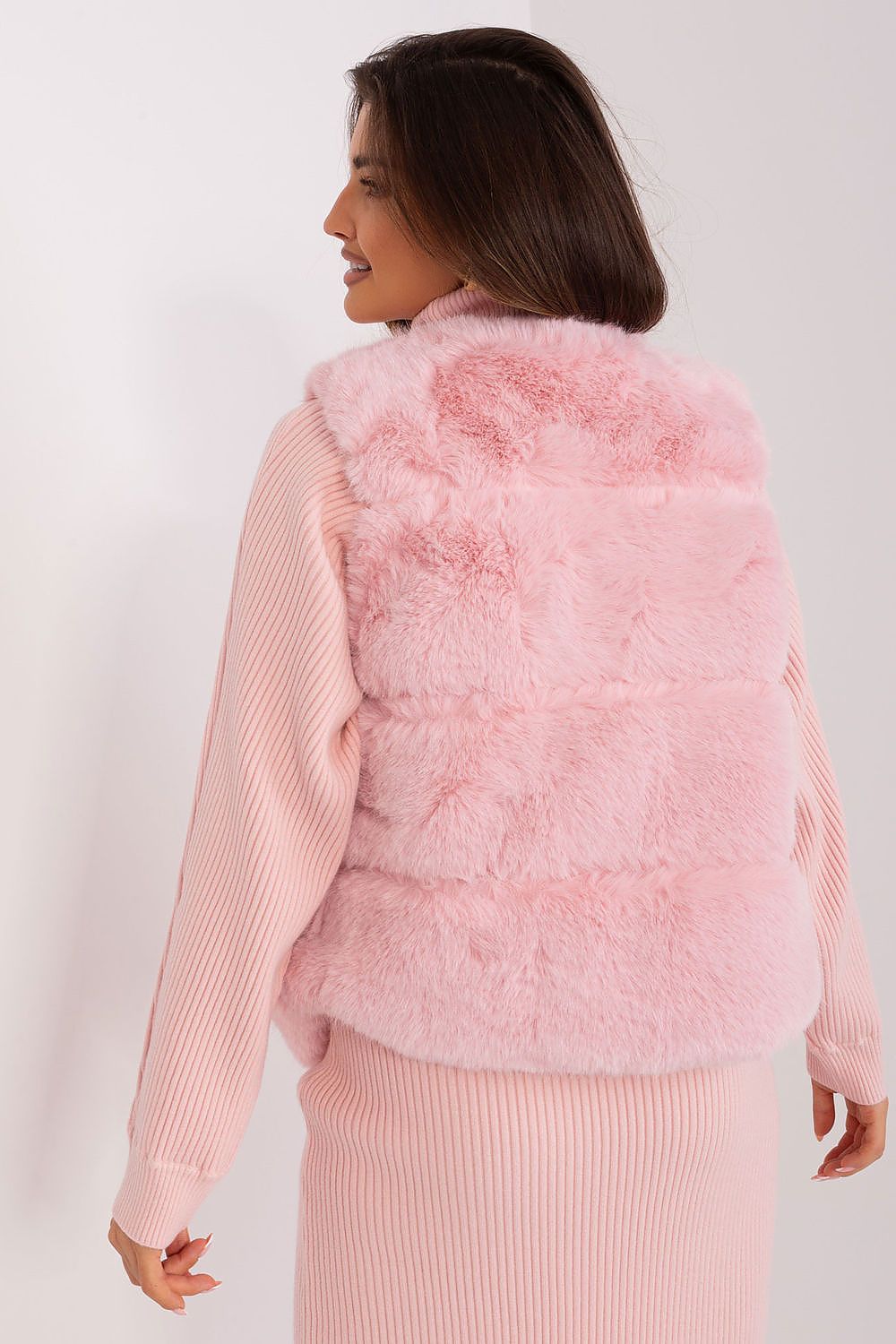 Soft and sophisticated fur vest by AT, featuring a stylish silhouette and accessible pockets for an upscale casual look.