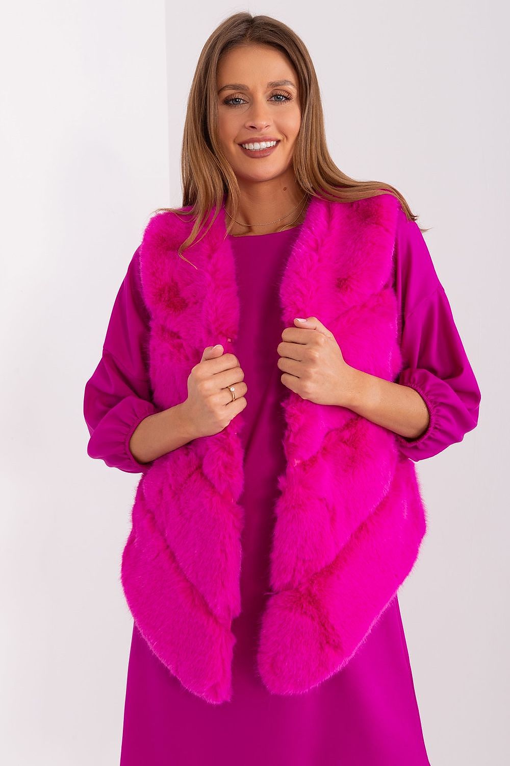 Stylish polyester fur gilet by AT, showcasing practical pockets and inner lining for warmth and comfort in a sophisticated look.