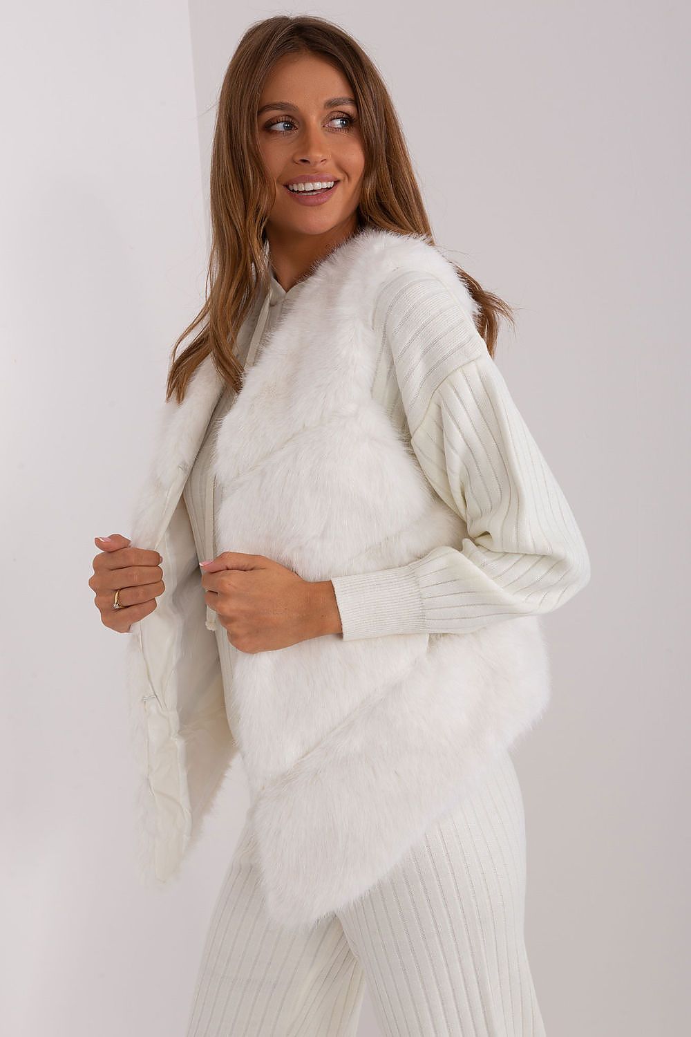 Elegant and warm women's fur vest by AT, perfect for casual occasions, displayed against a stylish backdrop.